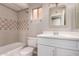 Bathroom featuring a vanity with storage and a shower-tub combo, perfect for relaxation at 1173 E Cochise Dr, Phoenix, AZ 85020