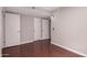 Neutral bedroom offers wood floors, crisp paint, and closet doors for plenty of storage at 1173 E Cochise Dr, Phoenix, AZ 85020