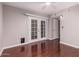 Bright bedroom features a ceiling fan, hardwood floors, and a door leading to an outside area at 1173 E Cochise Dr, Phoenix, AZ 85020