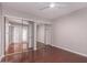 Spacious bedroom with ceiling fan and mirrored closet doors, offering ample storage and comfort at 1173 E Cochise Dr, Phoenix, AZ 85020