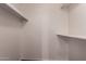 Walk-in closet contains simple shelving for storage and organization at 1173 E Cochise Dr, Phoenix, AZ 85020