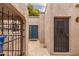 Charming courtyard view with a blue door and wrought iron details at 1173 E Cochise Dr, Phoenix, AZ 85020