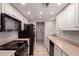 Well-lit galley kitchen with white cabinetry and modern appliances at 1173 E Cochise Dr, Phoenix, AZ 85020