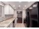 Galley kitchen features modern appliances and bright recessed lighting at 1173 E Cochise Dr, Phoenix, AZ 85020