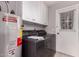 Functional laundry room includes washer, dryer, water heater and cabinetry at 1173 E Cochise Dr, Phoenix, AZ 85020
