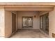 Outdoor patio area with tan stucco and green double doors at 1173 E Cochise Dr, Phoenix, AZ 85020
