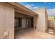 Outdoor patio with neutral stucco and double doors to interior at 1173 E Cochise Dr, Phoenix, AZ 85020