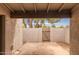 View from covered patio with tan stucco and a gate to exterior at 1173 E Cochise Dr, Phoenix, AZ 85020