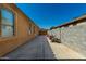 A view of the exterior facade featuring a concrete side yard and window at 1223 E Palo Verde Dr, Casa Grande, AZ 85122