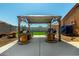 Backyard features a wooden pergola with seating, perfect for outdoor relaxation and entertaining at 1223 E Palo Verde Dr, Casa Grande, AZ 85122