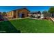 The grassy backyard features a pergola seating area and a storage shed at 1223 E Palo Verde Dr, Casa Grande, AZ 85122