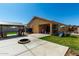 Expansive backyard featuring a patio, grassy area, firepit, and play structure for outdoor enjoyment at 1223 E Palo Verde Dr, Casa Grande, AZ 85122