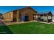 The backyard offers a pergola seating area and a grassy play space, ideal for relaxation and recreation at 1223 E Palo Verde Dr, Casa Grande, AZ 85122
