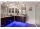 This bathroom boasts dual sinks with dark wood cabinets and large mirrors under modern lighting at 1223 E Palo Verde Dr, Casa Grande, AZ 85122
