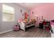 Cozy bedroom with pink and gray walls, a window and decoratively decorated bed at 1223 E Palo Verde Dr, Casa Grande, AZ 85122