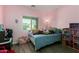 Cozy bedroom with pink walls, a window and decoratively decorated bed at 1223 E Palo Verde Dr, Casa Grande, AZ 85122