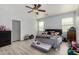 Large bedroom features hardwood floors, overhead fan and cow print decor at 1223 E Palo Verde Dr, Casa Grande, AZ 85122