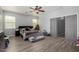 Large bedroom features hardwood floors, overhead fan and cow print decor at 1223 E Palo Verde Dr, Casa Grande, AZ 85122