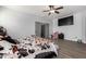 Large bedroom features hardwood floors, overhead fan and cow print decor at 1223 E Palo Verde Dr, Casa Grande, AZ 85122