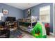 Blue walled bedroom features a bunk bed, a window and a play tent at 1223 E Palo Verde Dr, Casa Grande, AZ 85122