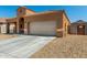 Stylish single-story home showcasing desert landscaping, a tile roof, and an attached two-car garage at 1223 E Palo Verde Dr, Casa Grande, AZ 85122
