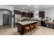 Bright kitchen features a large island with seating and stainless steel appliances at 1223 E Palo Verde Dr, Casa Grande, AZ 85122