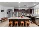 Open kitchen featuring a center island with seating, stainless steel appliances, and ample cabinet storage at 1223 E Palo Verde Dr, Casa Grande, AZ 85122