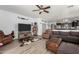 Inviting living room with wood-look floors, a ceiling fan, and a comfortable seating arrangement at 1223 E Palo Verde Dr, Casa Grande, AZ 85122