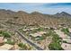 Scenic aerial view of a desert community featuring beautiful homes nestled in a picturesque mountain landscape at 12448 N 129Th Pl, Scottsdale, AZ 85259