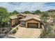 Aerial view of a single-story home with a tile roof, driveway, and well-maintained landscaping at 12448 N 129Th Pl, Scottsdale, AZ 85259