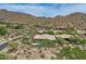 Scenic aerial view of a desert home with a pool, surrounded by native vegetation and mountain views at 12448 N 129Th Pl, Scottsdale, AZ 85259