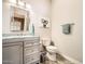 Neat bathroom featuring a vanity, toilet, and large mirror at 12448 N 129Th Pl, Scottsdale, AZ 85259