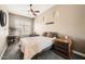 Cozy bedroom with a neutral palette, plantation shutters, and a ceiling fan at 12448 N 129Th Pl, Scottsdale, AZ 85259