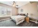 Comfortable bedroom featuring a ceiling fan, carpeted floor, and a window for natural light at 12448 N 129Th Pl, Scottsdale, AZ 85259