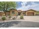 Charming single-story home featuring desert landscaping and a private two-car garage at 12448 N 129Th Pl, Scottsdale, AZ 85259