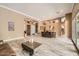 Bright, open-concept living and dining room with modern wood-look tile flooring at 12448 N 129Th Pl, Scottsdale, AZ 85259