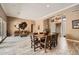 Spacious living area featuring wood-look tile flooring, large dining table, and stylish furnishings at 12448 N 129Th Pl, Scottsdale, AZ 85259