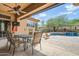 Outdoor patio area with a pool, TV, and outdoor seating, perfect for relaxation and entertainment at 12448 N 129Th Pl, Scottsdale, AZ 85259