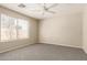 Relaxing bedroom with carpeted floors, a ceiling fan, and natural light from a window at 125 N 22Nd Pl # 53, Mesa, AZ 85213