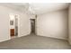 Spacious primary bedroom featuring carpeted floors, a ceiling fan, and walk-in closet at 125 N 22Nd Pl # 53, Mesa, AZ 85213