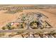 Wide aerial shot of the neighborhood with well-manicured properties, lush grass and private swimming pools at 1409 E Dove Pl, Casa Grande, AZ 85122