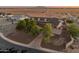 A scenic aerial view of a single Gathering home showcasing mature trees and circular driveway at sunset at 1409 E Dove Pl, Casa Grande, AZ 85122