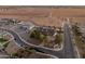 An aerial view of a luxurious home featuring mature trees and a vast open space beyond the street at 1409 E Dove Pl, Casa Grande, AZ 85122