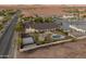 Bird's eye view of home with pool, tennis court, outdoor kitchen, gazebo, mountain views and lush yard at 1409 E Dove Pl, Casa Grande, AZ 85122