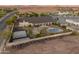 Beautiful aerial view of home, pool, outdoor kitchen, and tennis and basketball court with mountain views at 1409 E Dove Pl, Casa Grande, AZ 85122