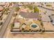 Beautiful aerial view of home, pool, outdoor kitchen, and tennis and basketball court on a spacious manicured lot at 1409 E Dove Pl, Casa Grande, AZ 85122