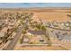 Wide aerial view of this property and neighborhood showing the mountain views and proximity to shopping and farmland at 1409 E Dove Pl, Casa Grande, AZ 85122