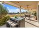 Expansive covered patio with dining and lounge areas, overlooking a well-maintained yard and trampoline at 1409 E Dove Pl, Casa Grande, AZ 85122