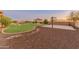 Spacious backyard with a basketball court, gazebo, fire pit and lush green lawn at 1409 E Dove Pl, Casa Grande, AZ 85122