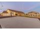 Back exterior view showcasing the basketball court, covered patio, and beautiful landscaping at 1409 E Dove Pl, Casa Grande, AZ 85122